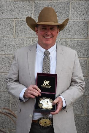 Eric Drees holding his award