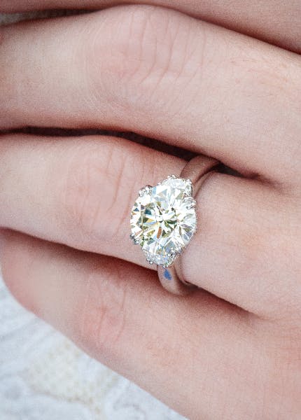 Round diamond engagement ring with side diamond accents