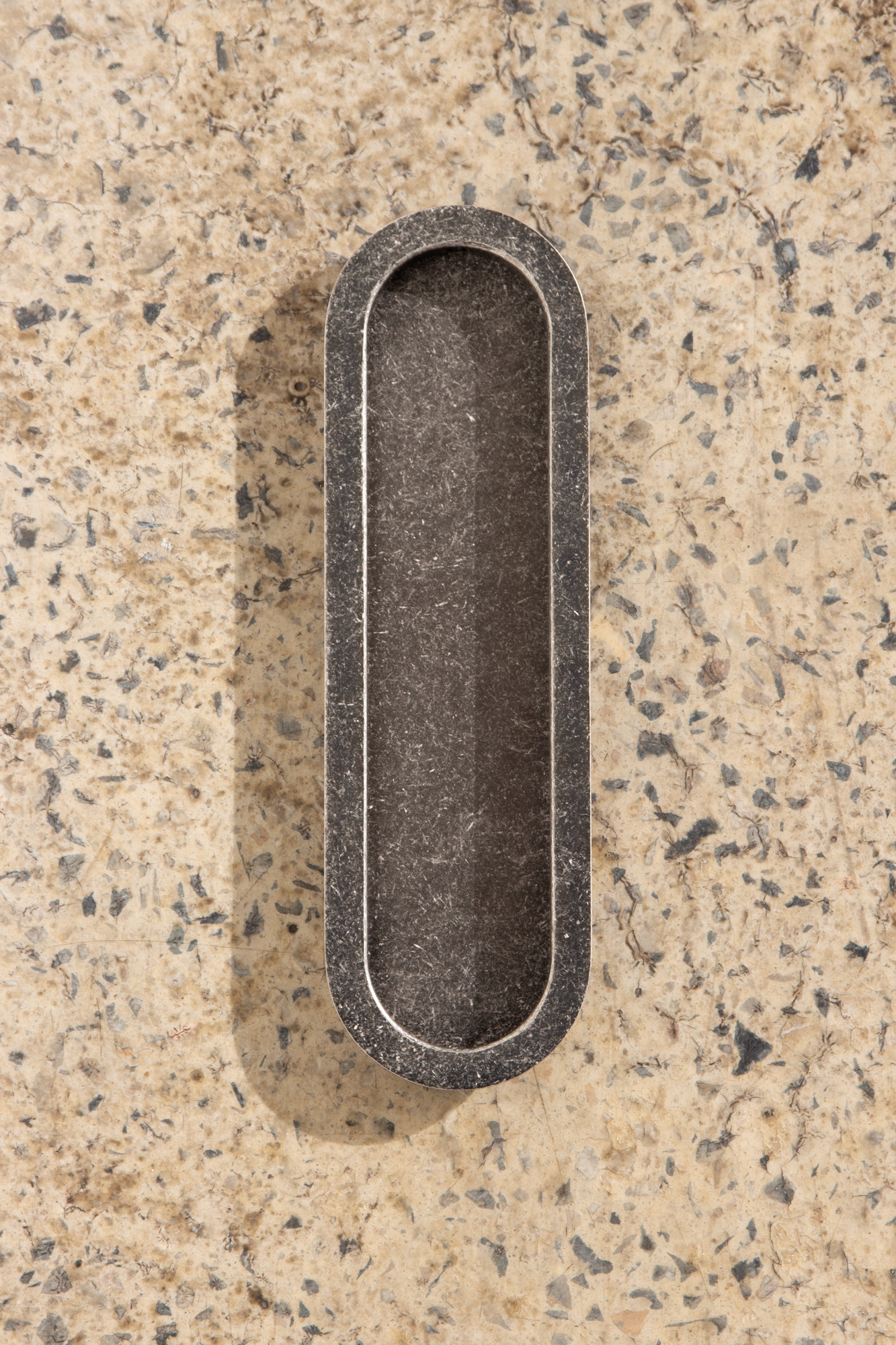 Lo and Co Luna Flush pull in tumbled nickel on terrazzo floor