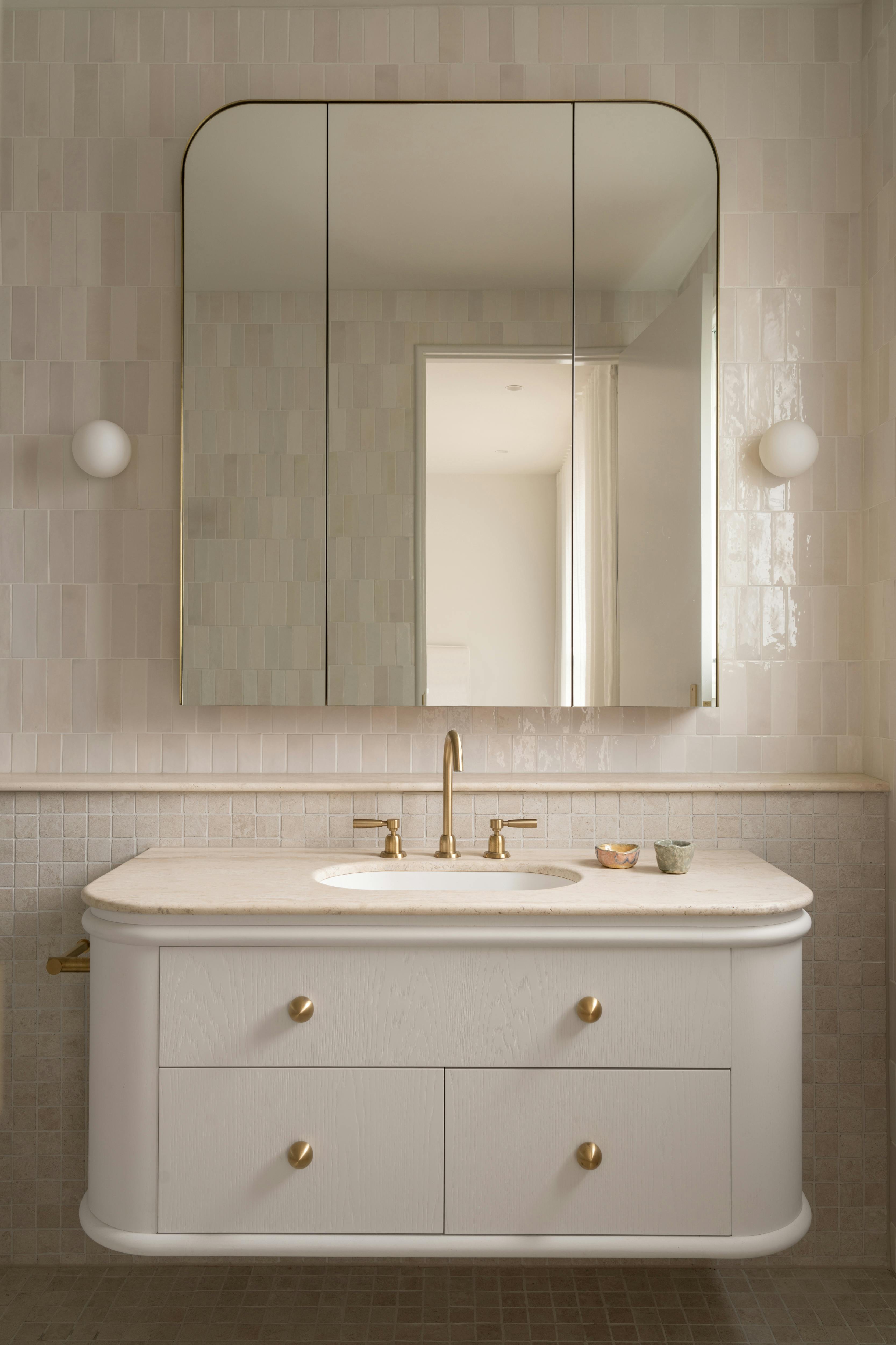 Bathroom with Lo and CO Sphere Knob in brass on white cabinets