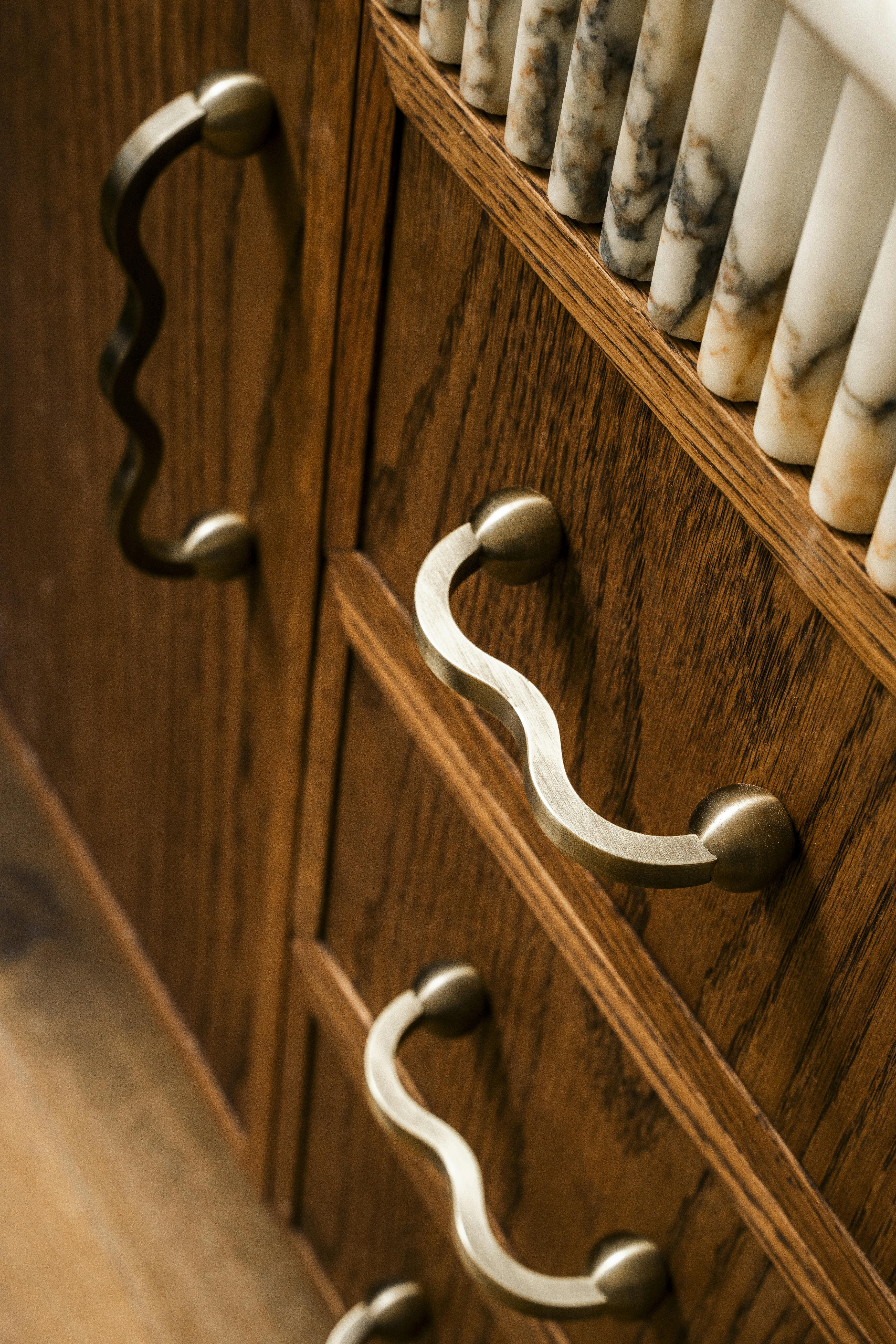 Lo and Co Capri wavy handles on a wooden cabinet in kitchen