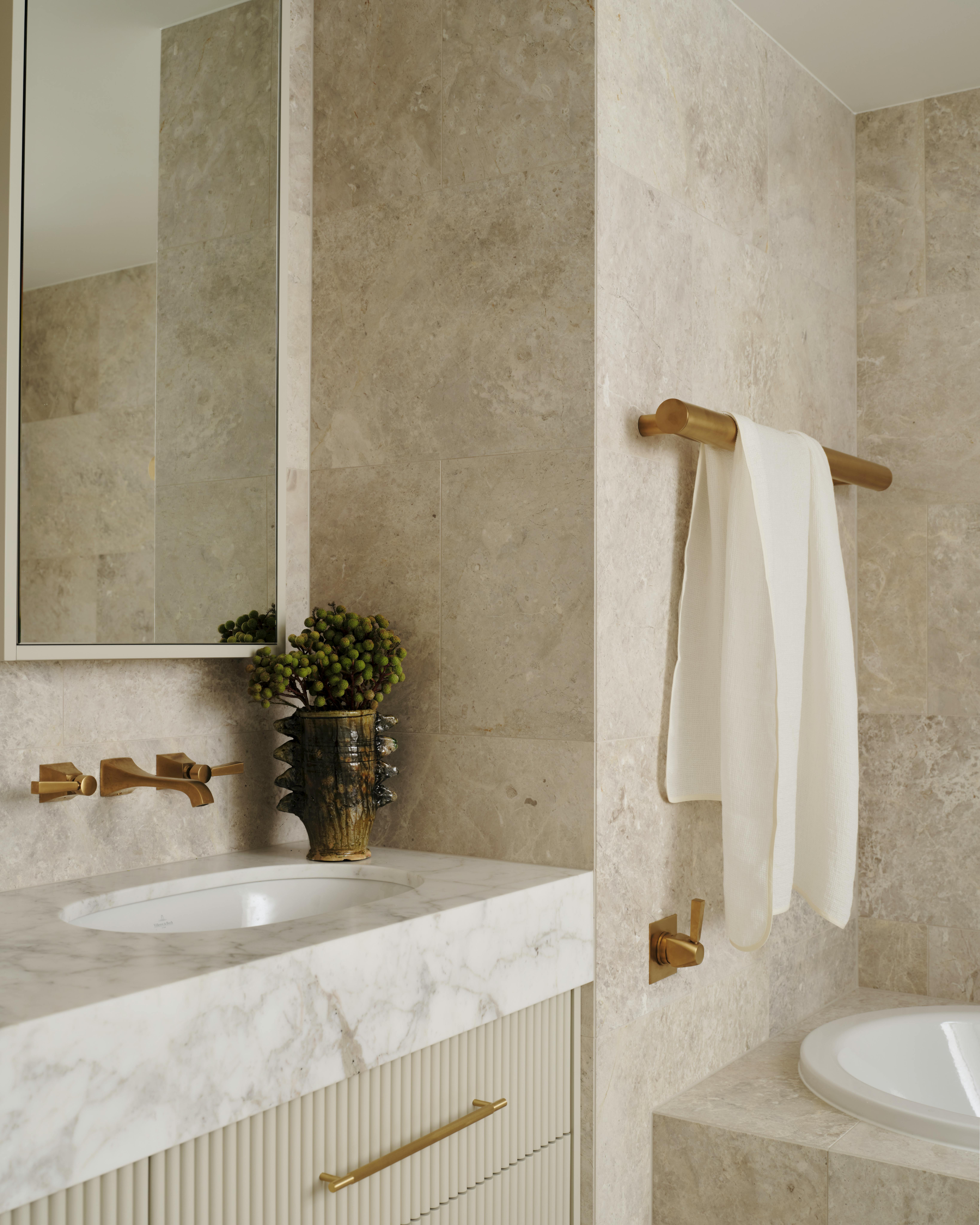 Lo and Co bathroom with gold brass hardware