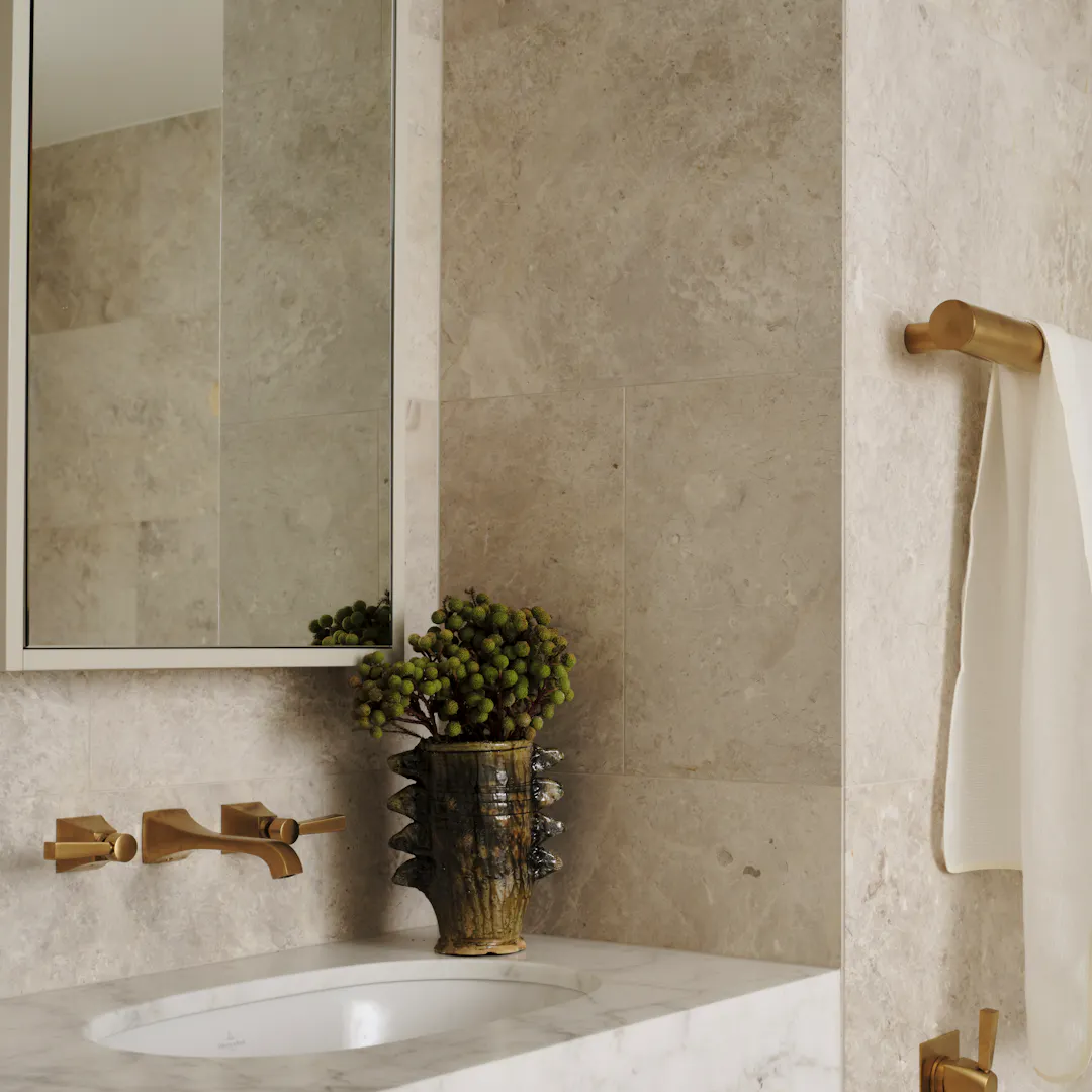 Lo and Co bathroom with gold brass hardware