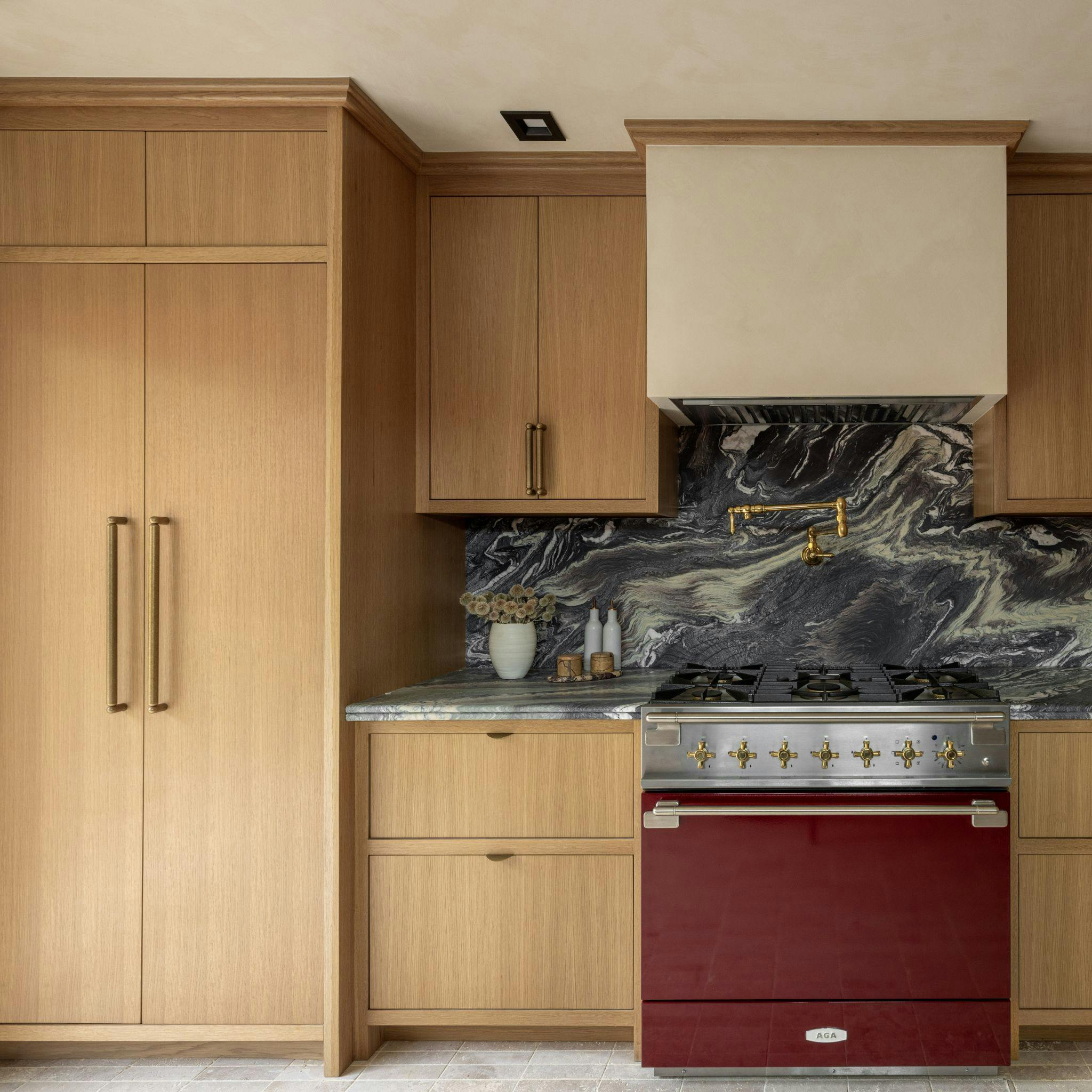 Kitchen with two brass appliance pull handles by Lo and Co Interiors