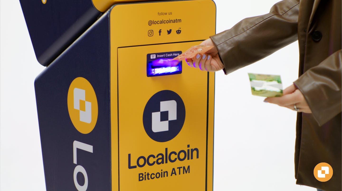 User inserting cash into a Bitcoin ATM