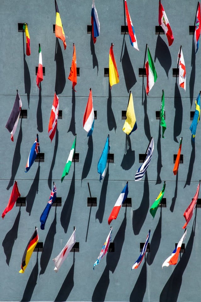 a wall of flags shows some of the many countries where work permits are available for foreign nationals