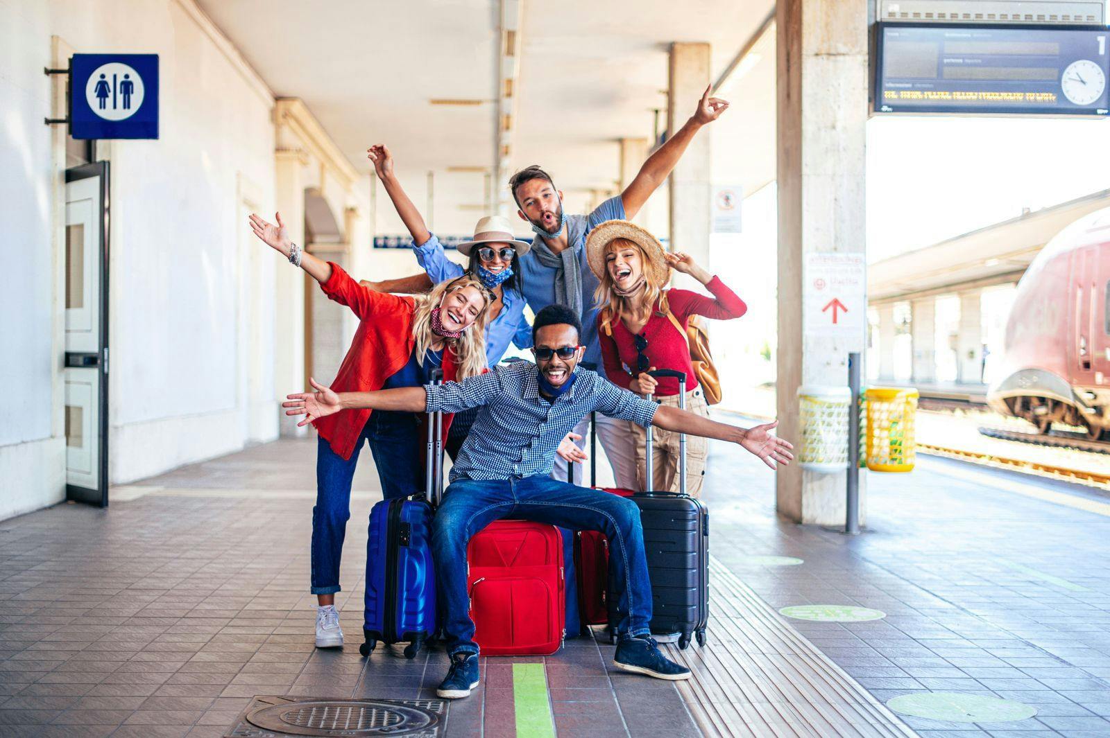 global team gathering at a train station for a work retreat