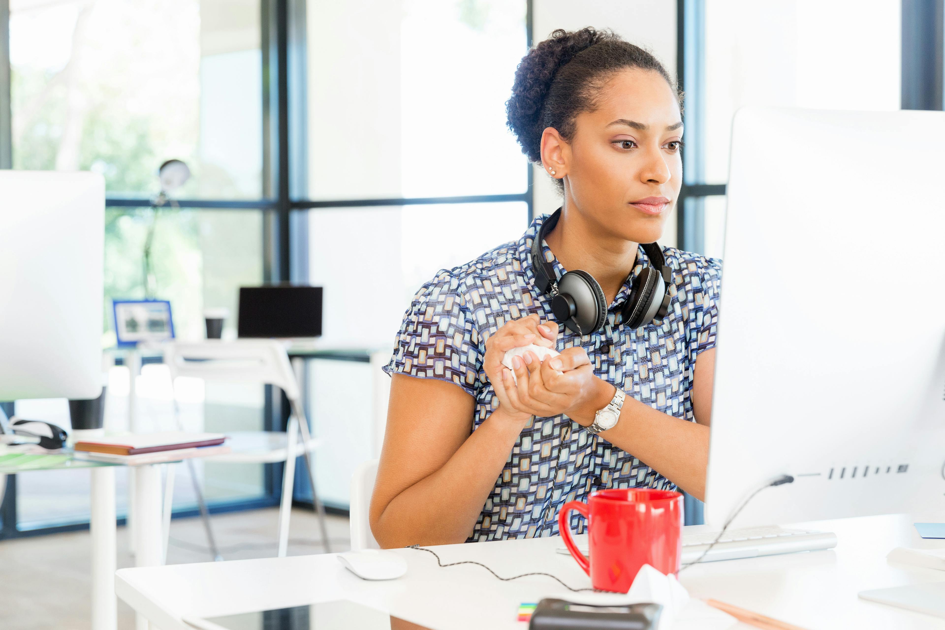 Young black worker sitting at an office computer