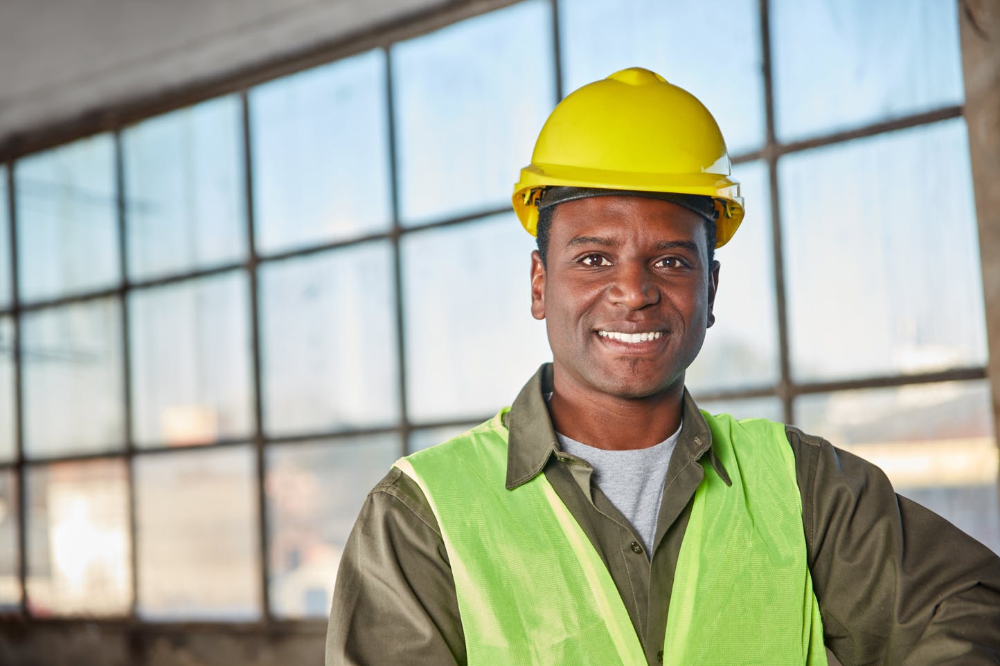 African construction worker in vest and hardhat on the jobsite