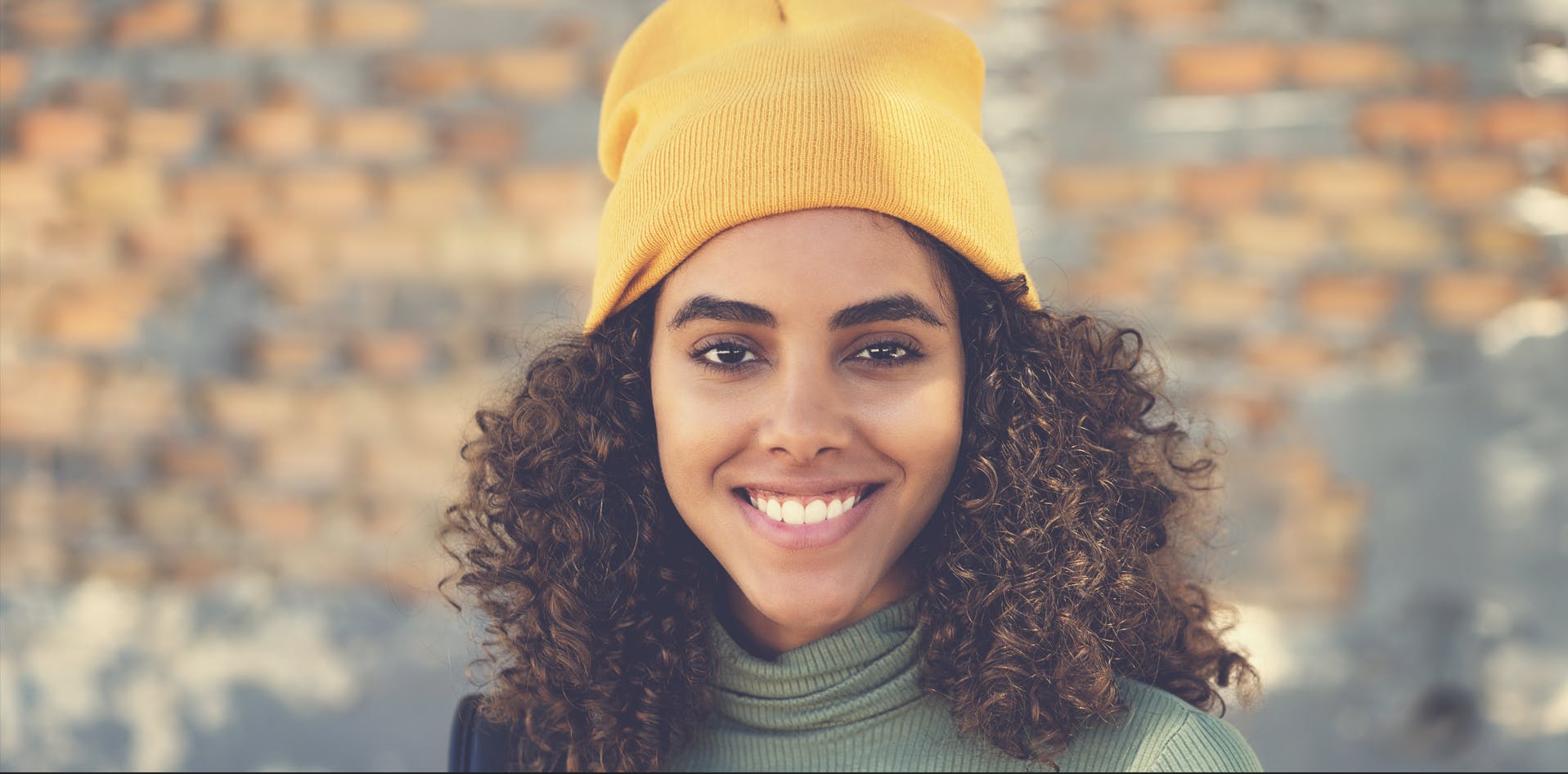 a young woman smiles after applying for an H-1B visa in the US