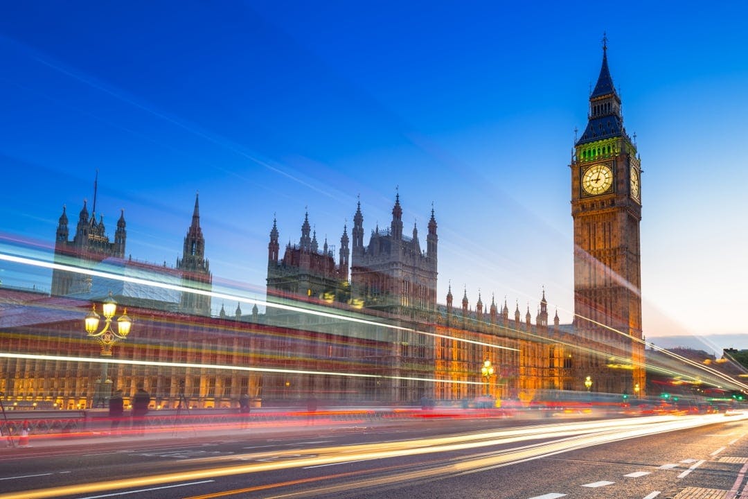 a busy street in the UK, showing Big Ben, reflects what it's like to hire someone from outside the UK