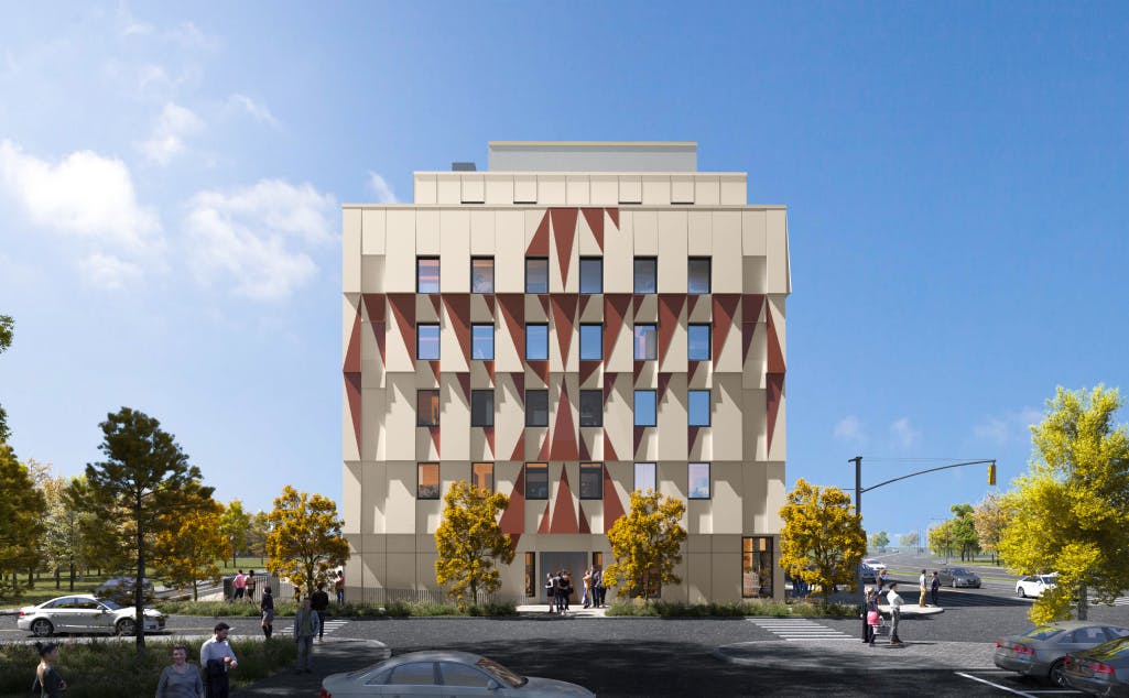 Front view of 2217 Kingston, a modern multi-story building with a unique geometric facade, surrounded by trees and a clear sky