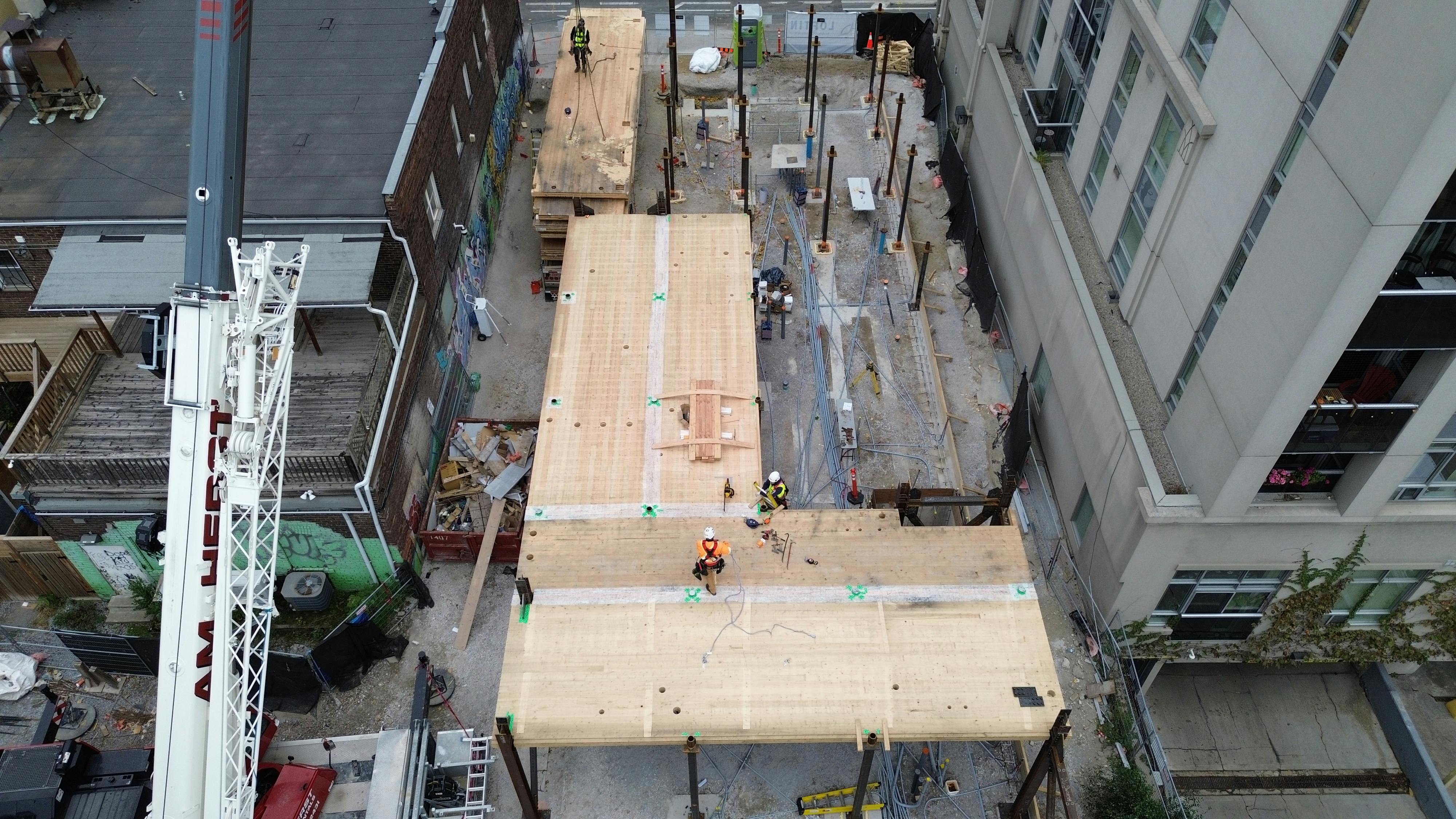 Aerial view of 215 Wellesley St, in-progress construction of an 8-storey infill transitional housing project.