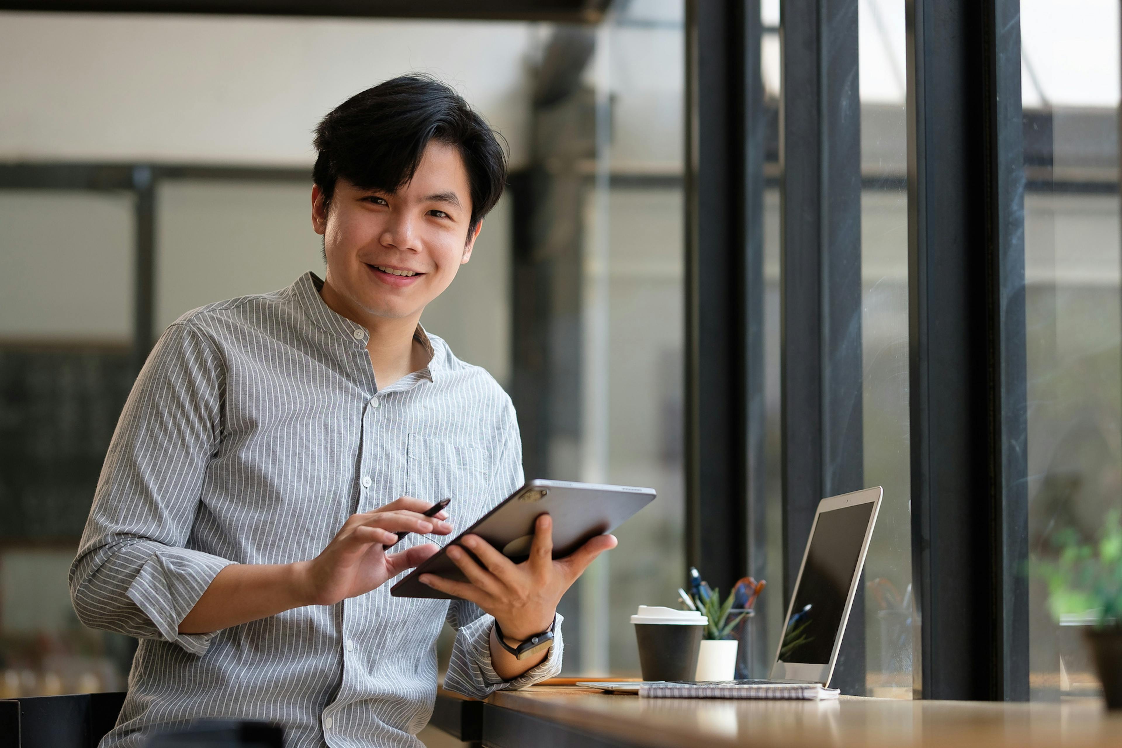 man working on laptop in C store