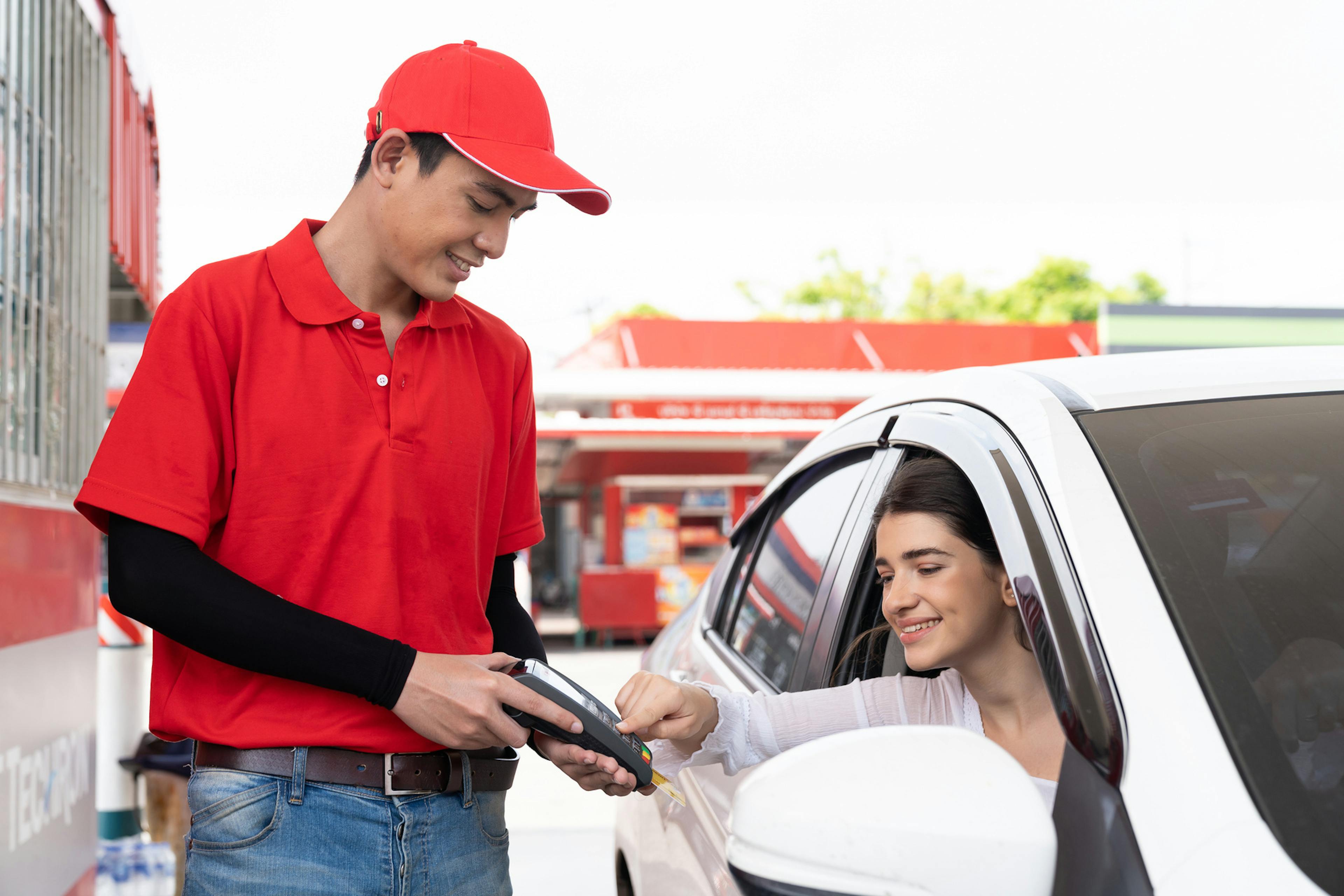 employee talking to customer at gas station