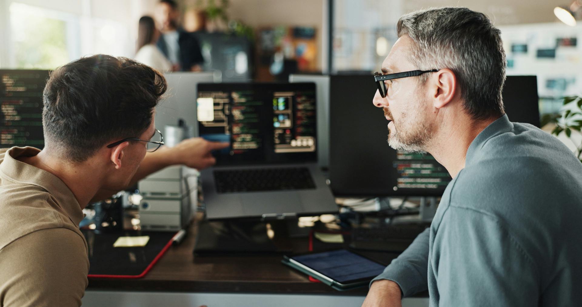 two digital team members working together
