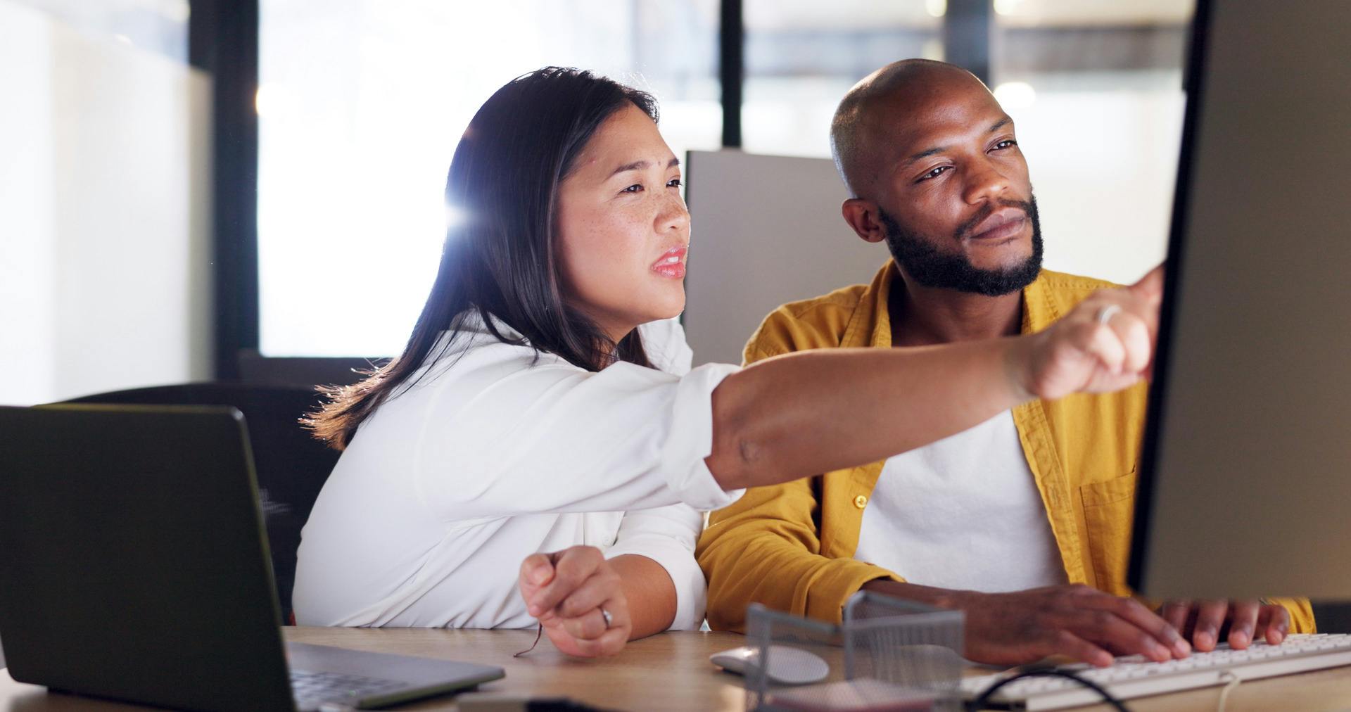 two people budgeting on a computer