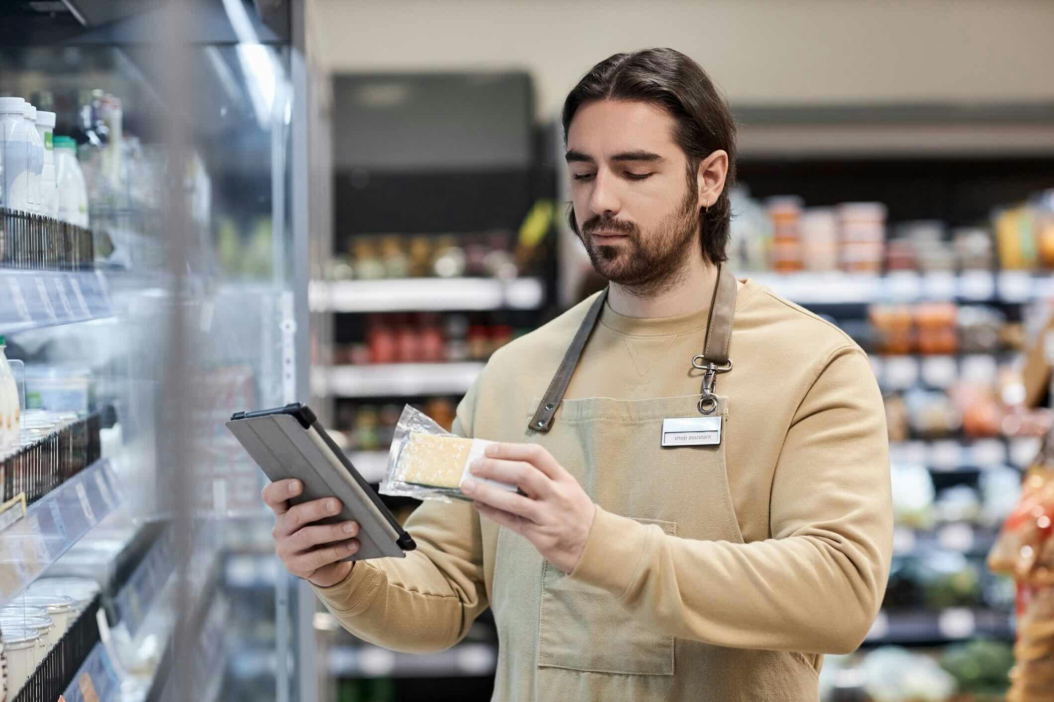man checking items in store