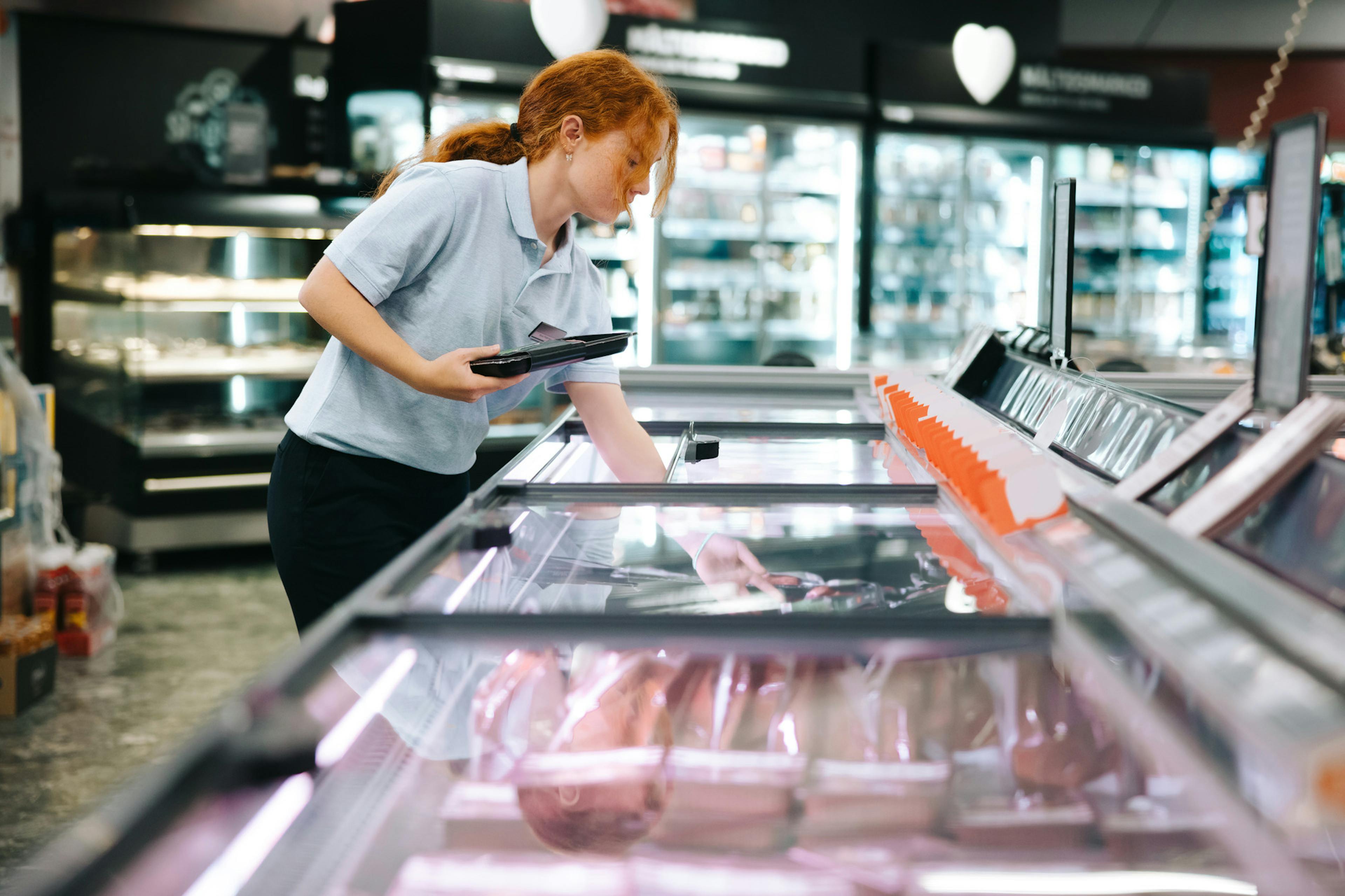 woman taking freezer inventory