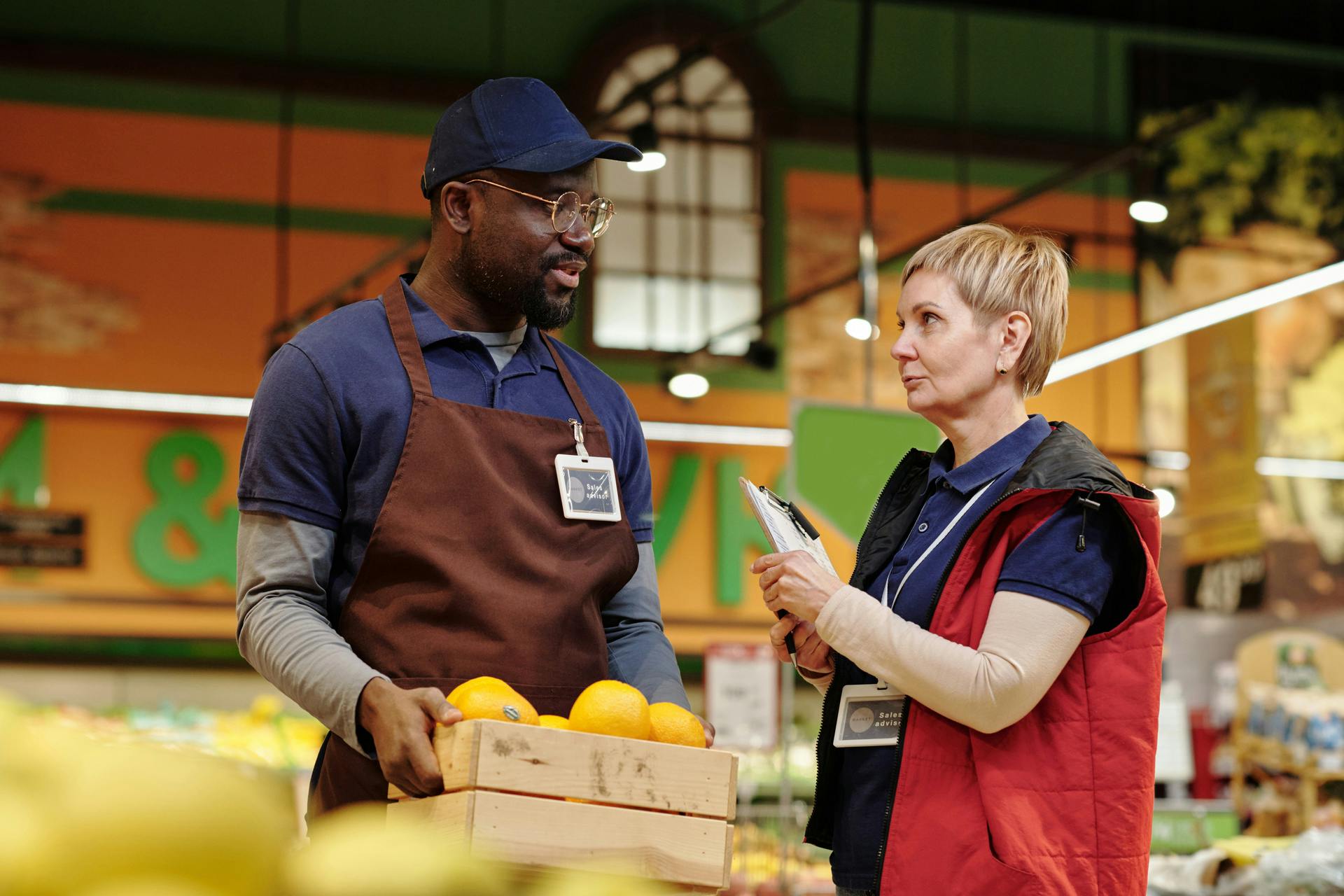 grocery manager talking to employee