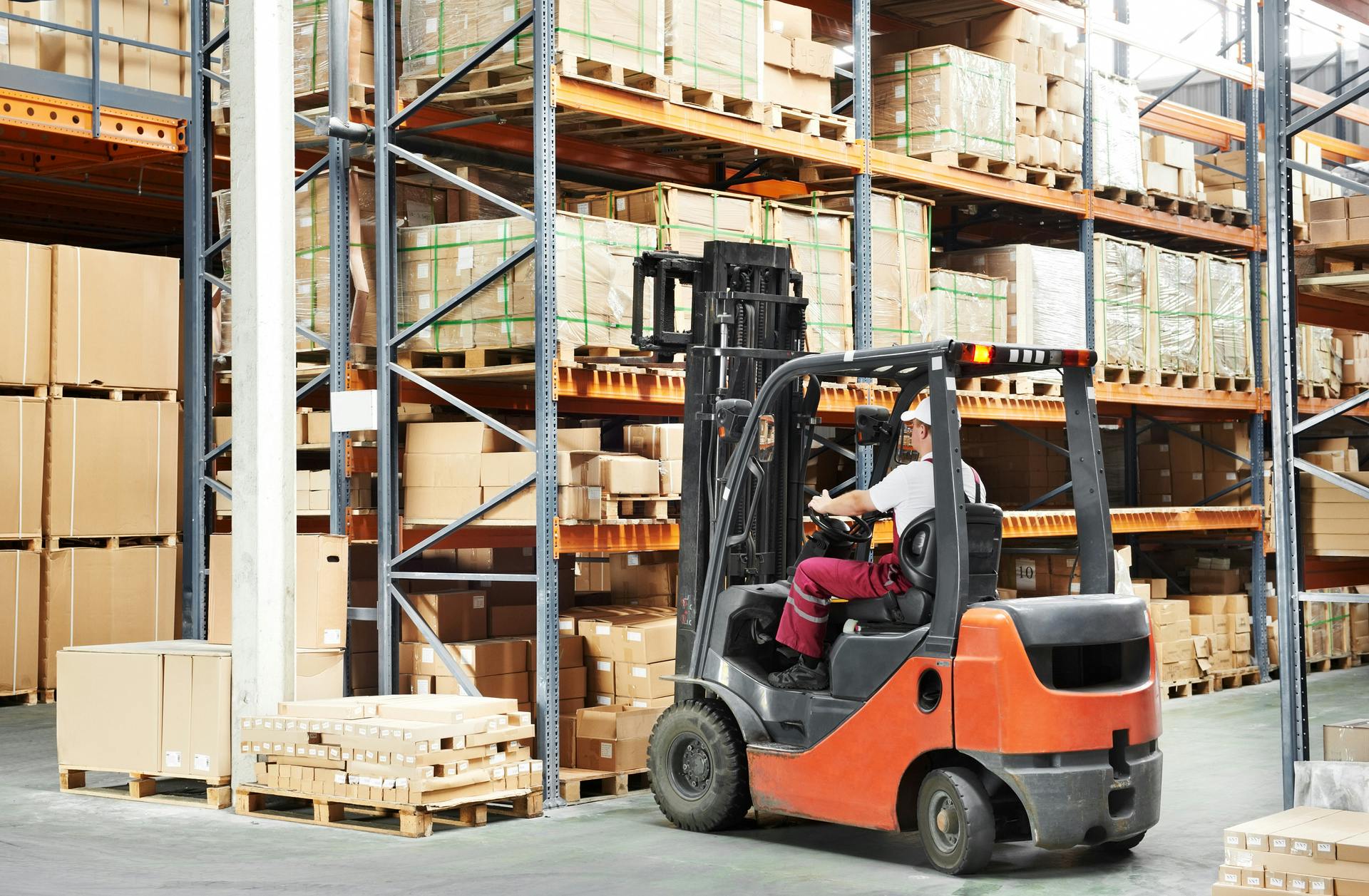 man operating forklift in warehouse