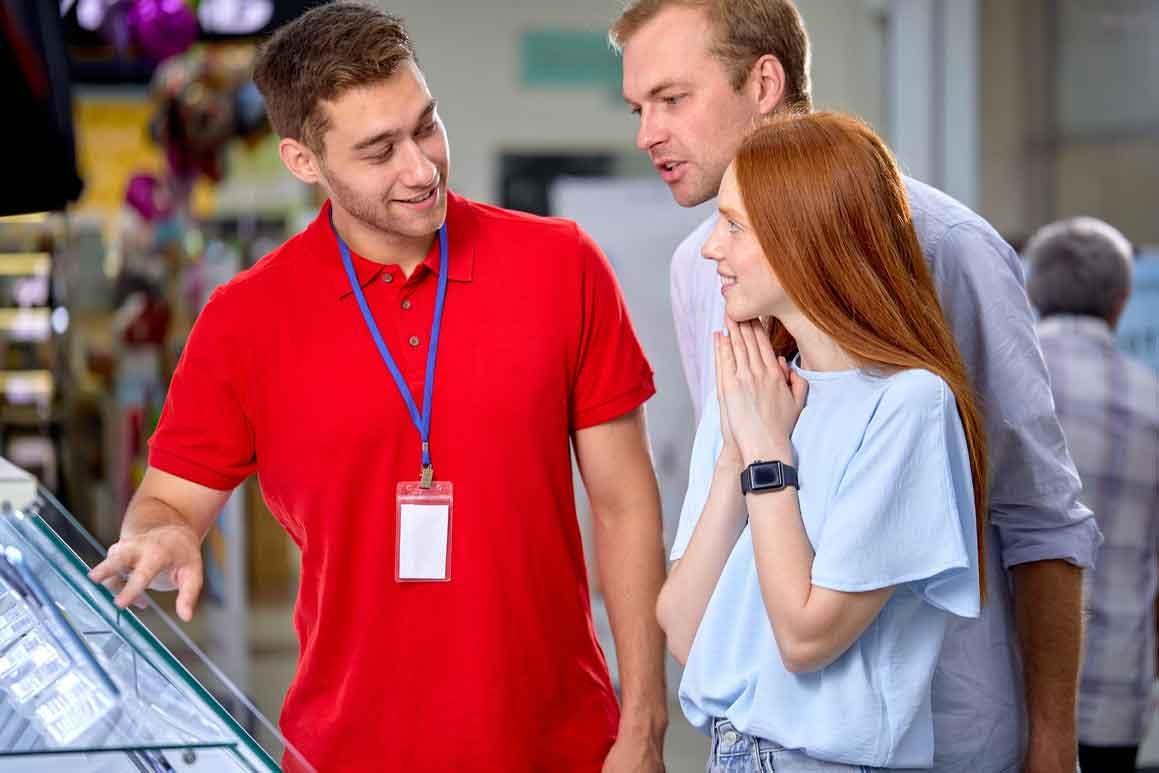 Customers asking retail employee about merchandise