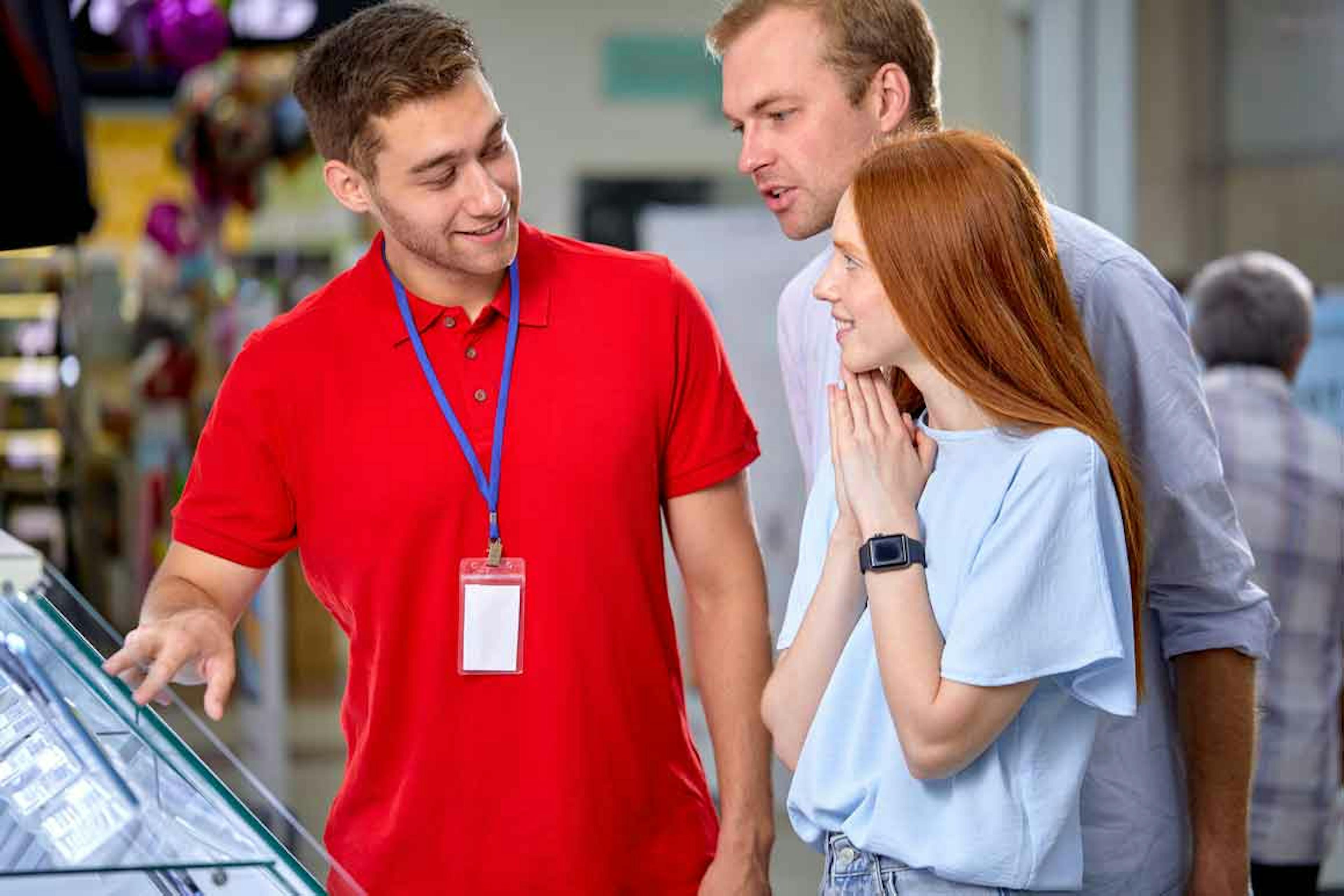 Customers asking retail employee about merchandise