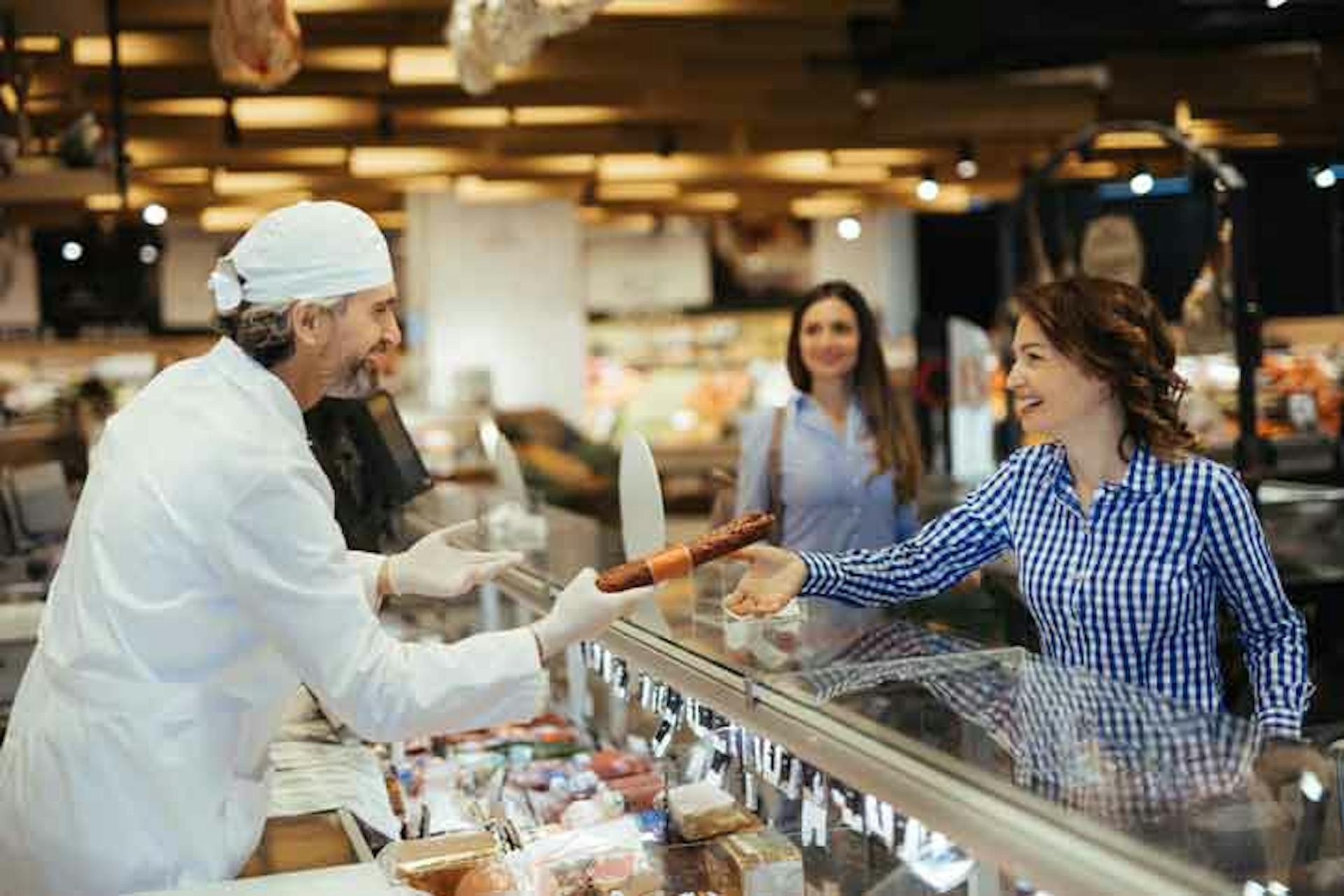 Fresh food department handing food to a customer