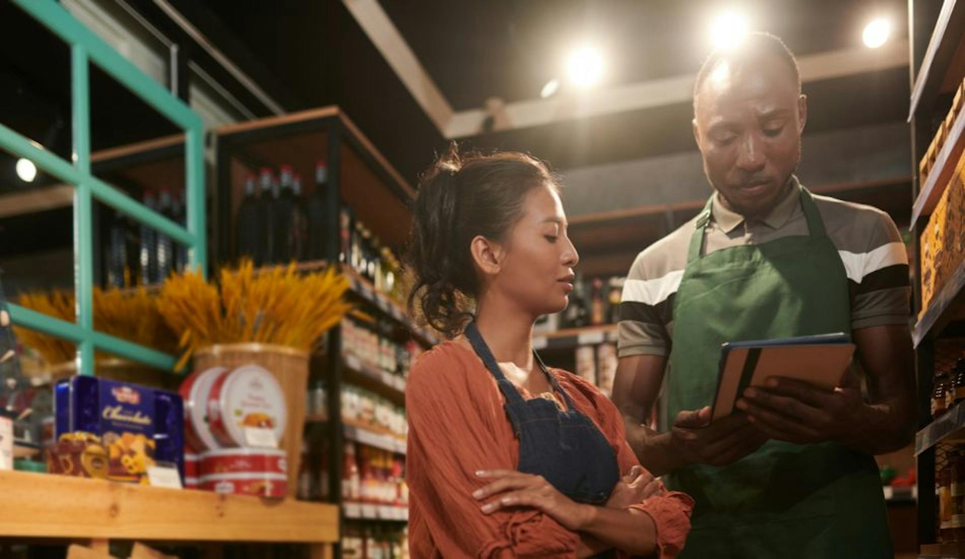 Employees in a specialty retail store looking at a tablet