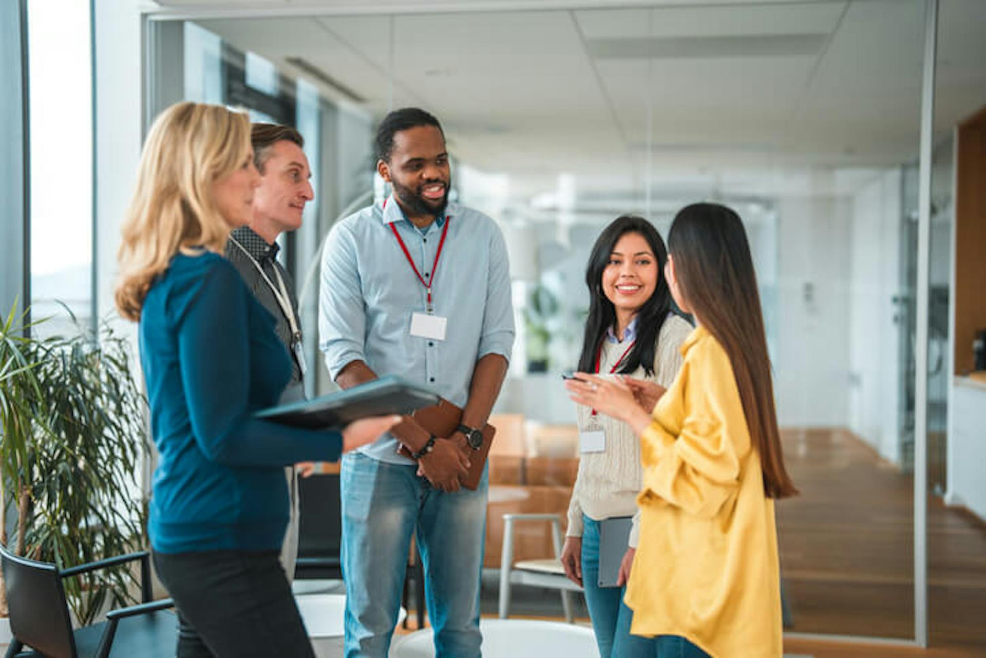 Smiling employees in standing meeting