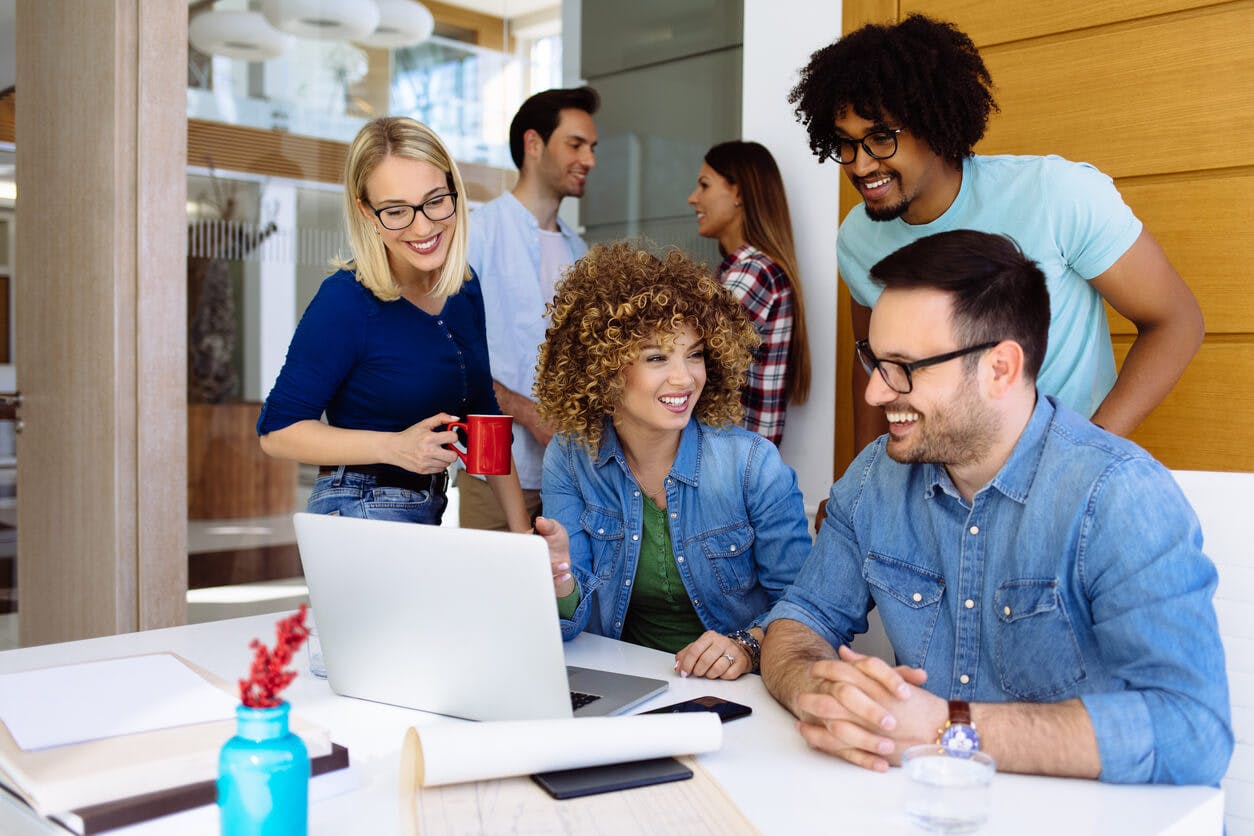 Office workers smiling in conference room