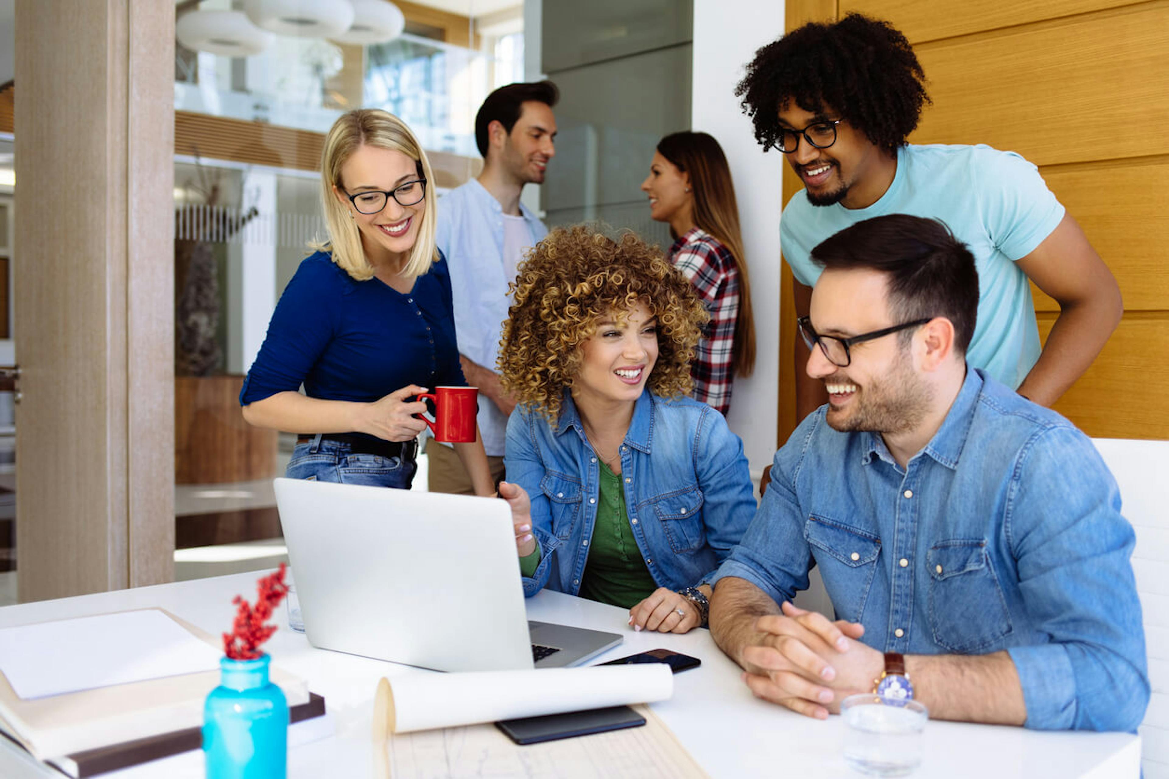 Office workers smiling in conference room