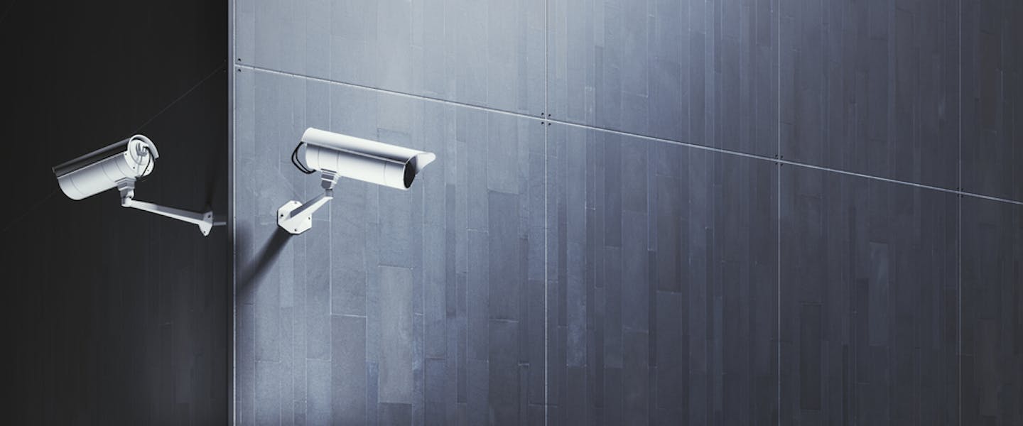CCTV surveillance camera on an empty gray wal