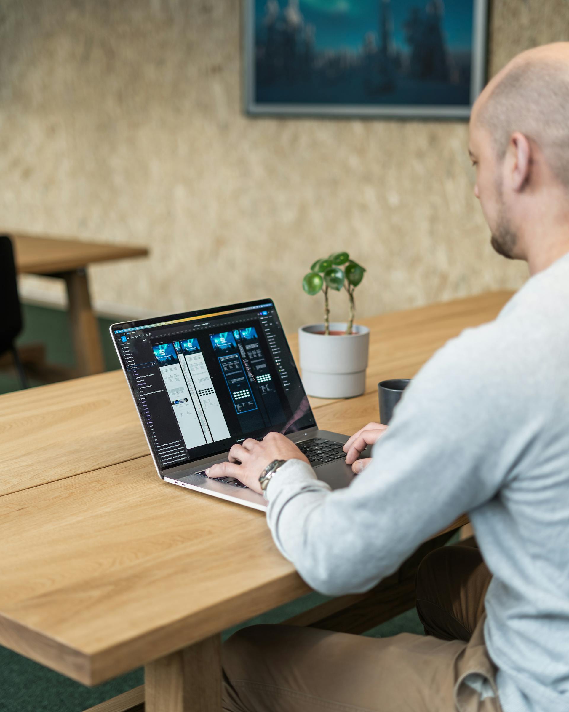 A man desiging a website on a laptop