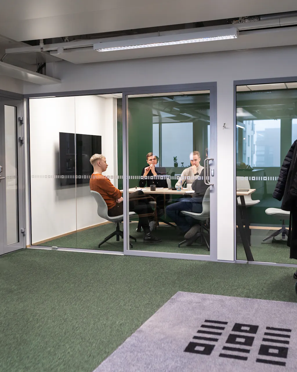 3 men sitting in a meeting room