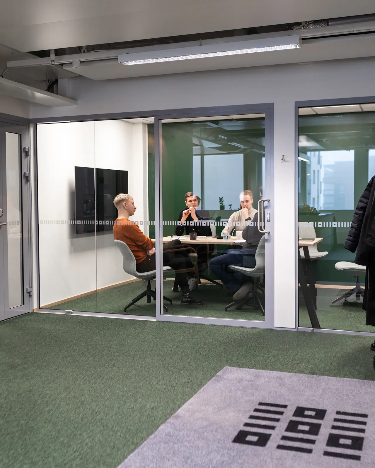 3 men sitting in a meeting room