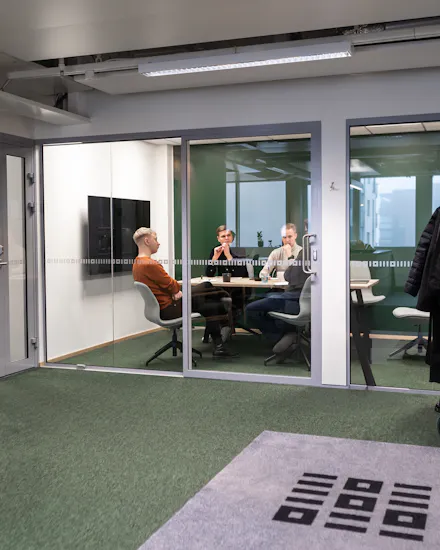 3 men sitting in a meeting room