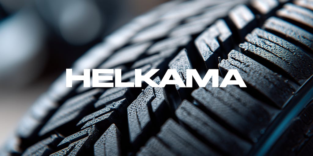 Close up of a car tire tread showing detailed texture and pattern - grip and road safety and Helkama's logo.