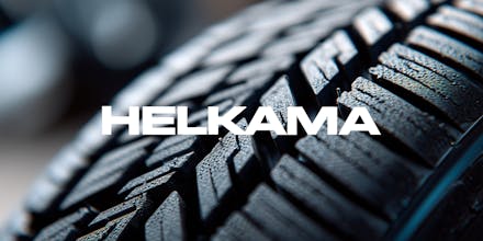 Close up of a car tire tread showing detailed texture and pattern - grip and road safety and Helkama's logo.