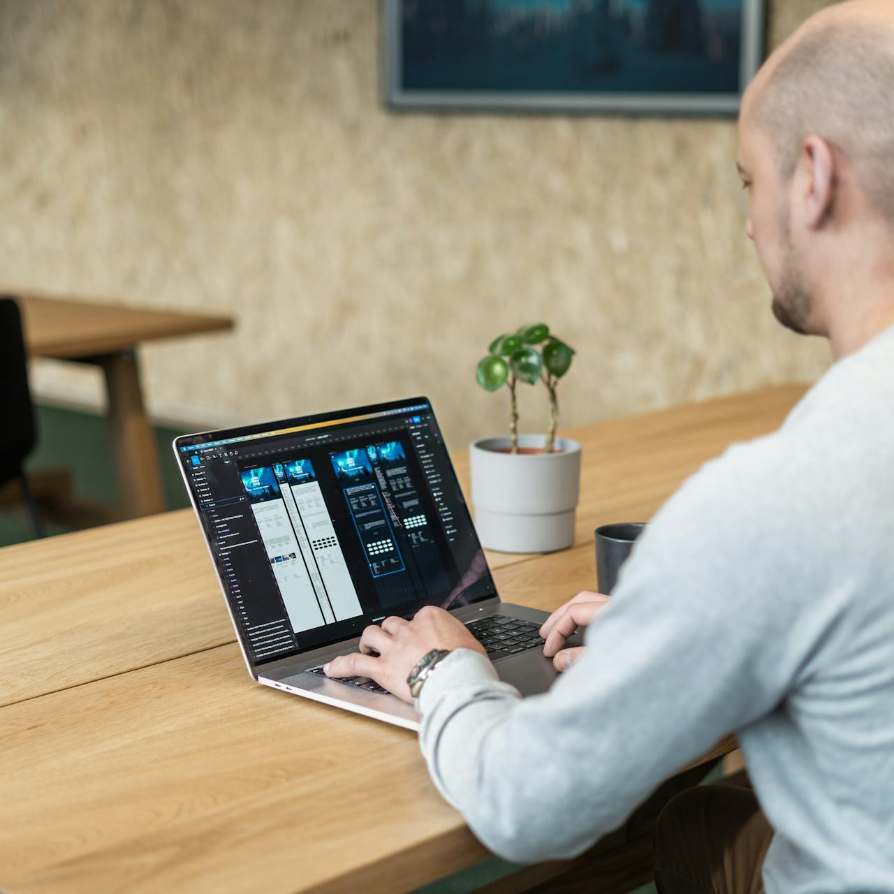 image of a back angle, of a ui/ux designer designing websites with figma