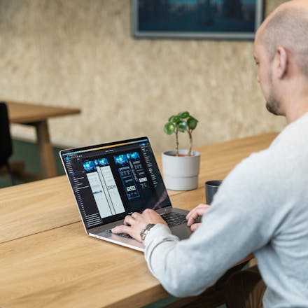 image of a back angle, of a ui/ux designer designing websites with figma