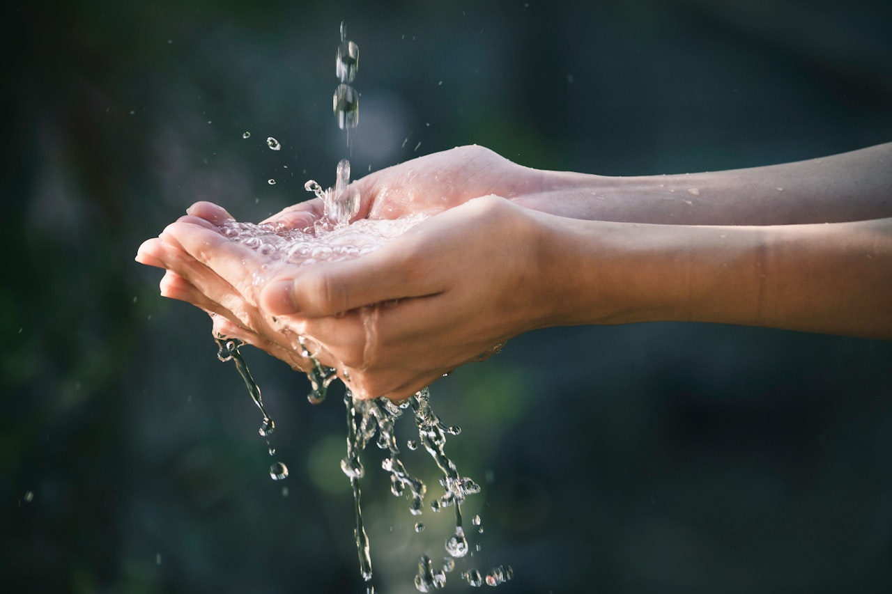 water runs into a person's hands