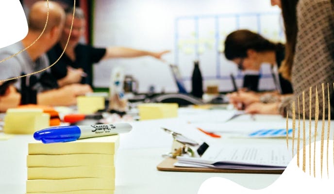 Lokion team workshopping at table covered in post-its and markers