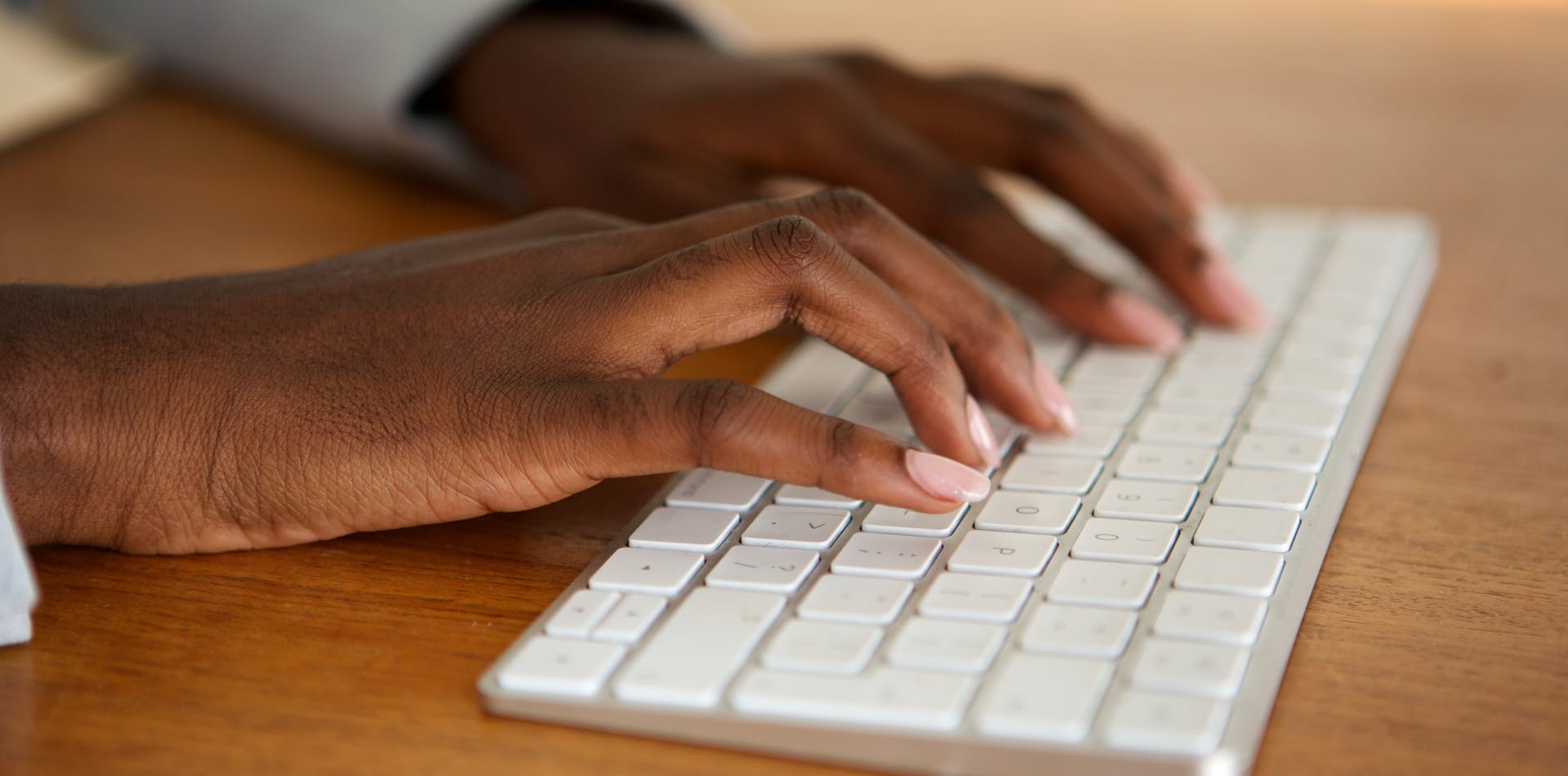 close up female hands typing on computer keyboard
