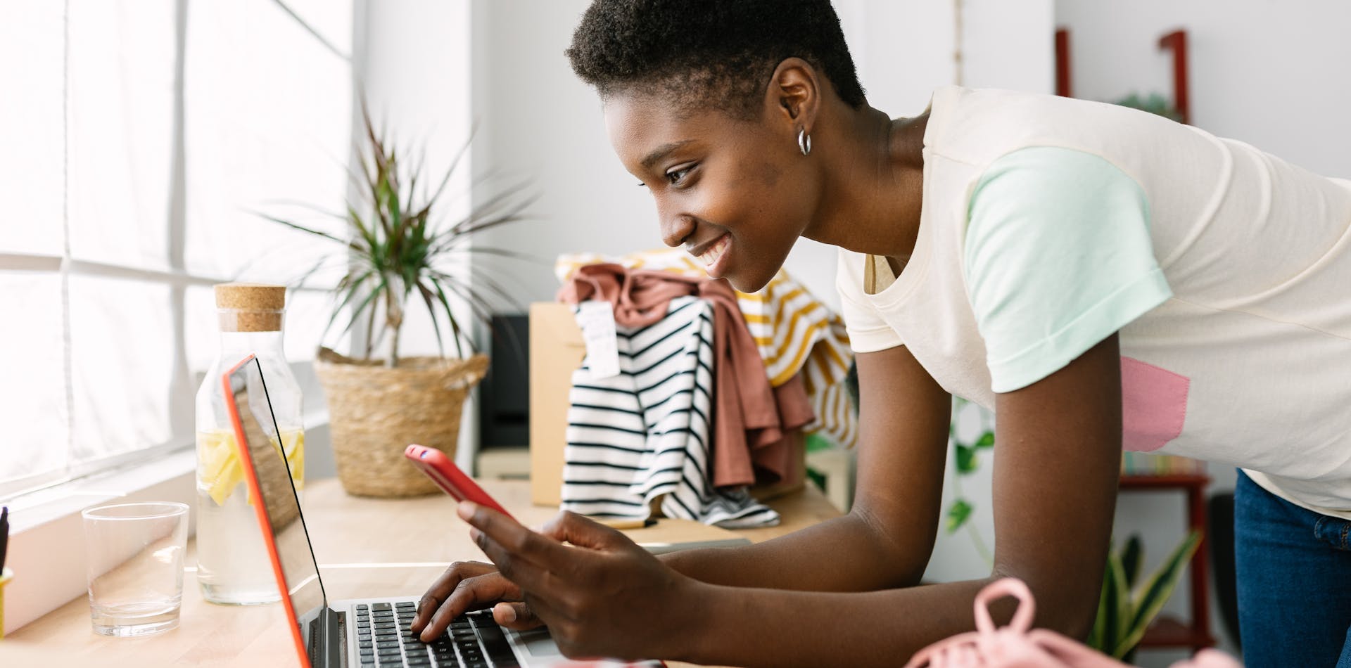 Small business owner shopping online with laptop and phone