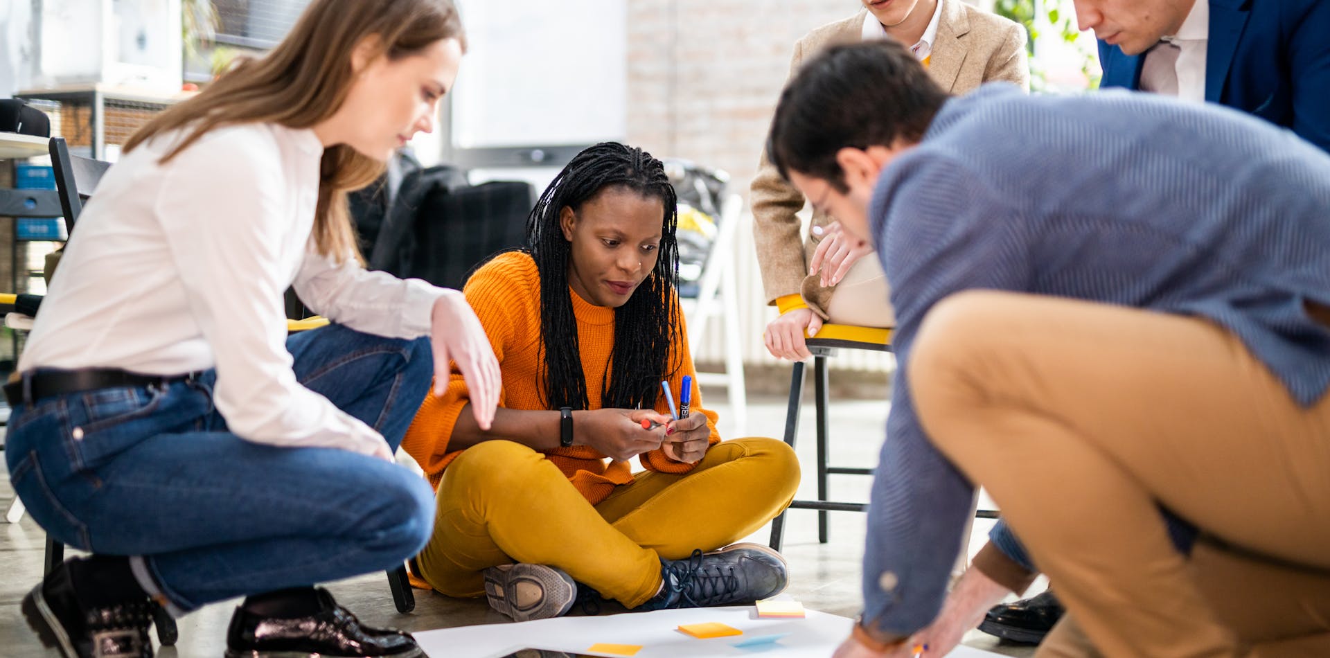 Team members working together on design thinking exercise
