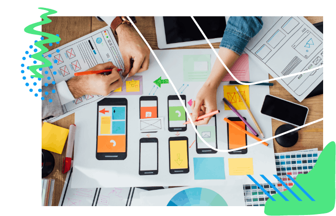 Looking down at table of mockups and design comps for mobile development