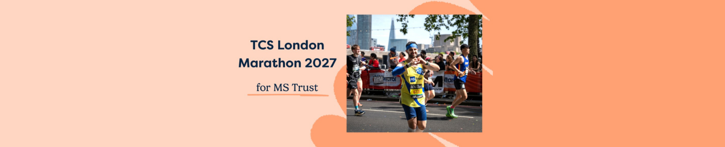 MS Trust runner taking part in the London Marathon, wearing a charity vest and making a heart shape with their hands.