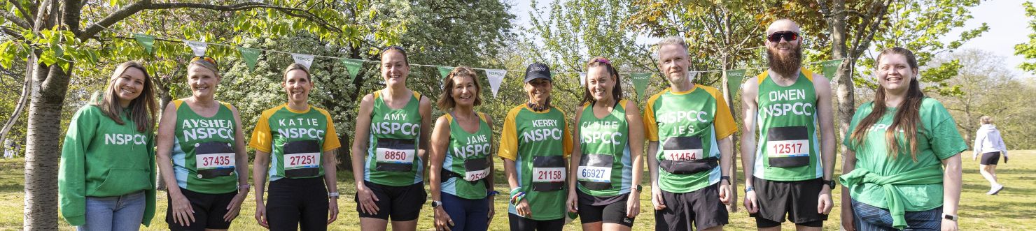 NSPCC marathoners smiling outside.