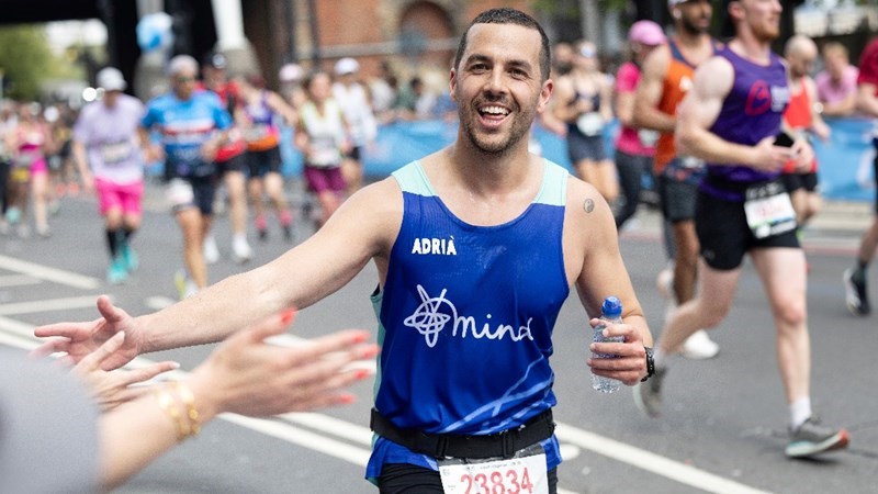 Mind marathoner running and smiling.